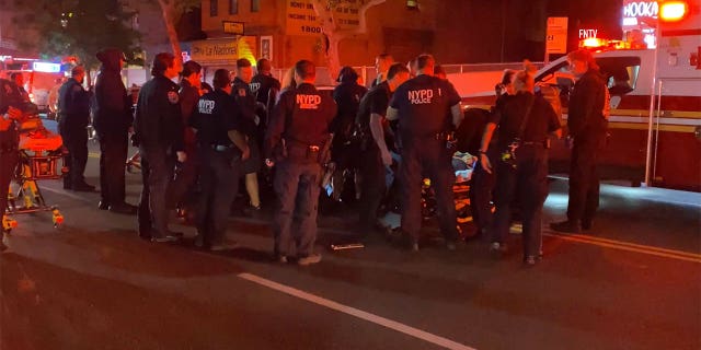 Two NYC police officers struck and dragged by fleeing vehicle: NYPD 5 NYPD officers standing on the street next to an ambulance.
