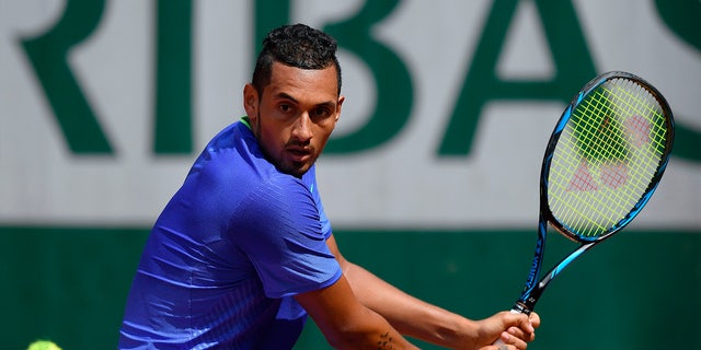 Nick Kyrgios returns the ball during the French Open