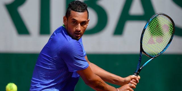 Nick Kyrgios returns the ball during the French Open