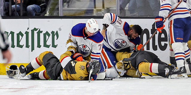 Oilers players in a fight