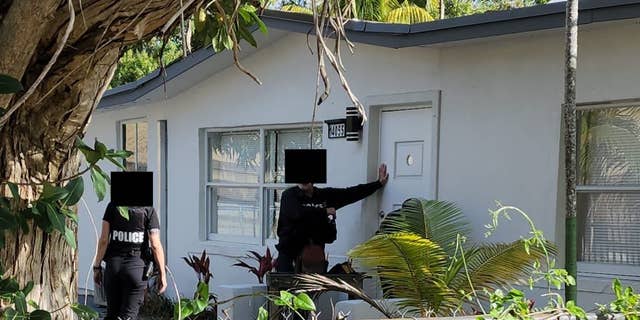 Police at the door of Sam's house.