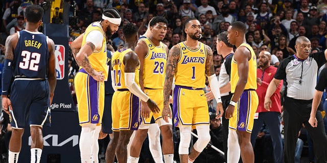 Los Angeles Lakers players look on