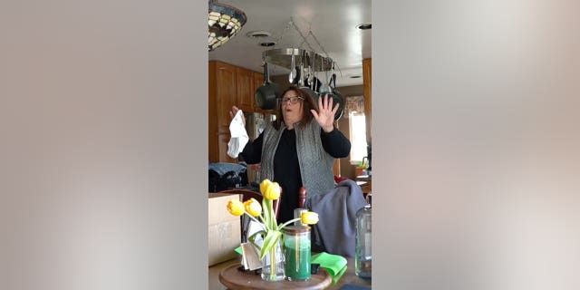 A woman reads a surprise pregnancy announcement.