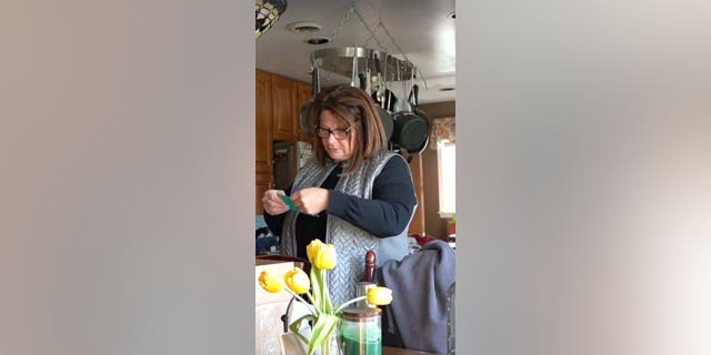 A woman reads a surprise pregnancy announcement.
