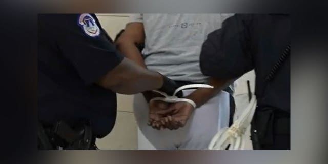Protestor handcuffed during debt ceiling protest on Capitol Hill