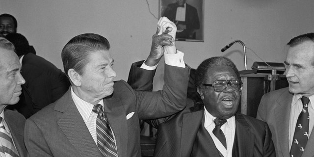 Then-Republican presidential candidate Ronald Reagan joins hands with civilian right leader Ralph Abernathy following his surprise endorsement of the former film star and California governor in 1980.