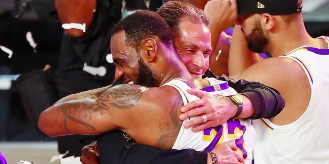 LeBron James hugs general manager Rob Pelinka