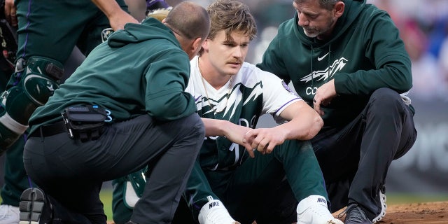 Trainers attend to Ryan Feltner