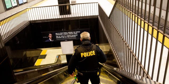 BART police officer descending into subway