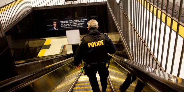 BART police officer descending into subway