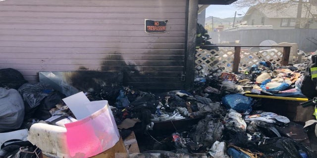 debris outside burnt out squatter house