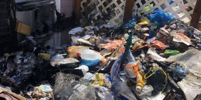 trash outside squatter home