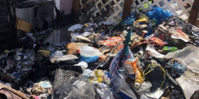 trash outside squatter home