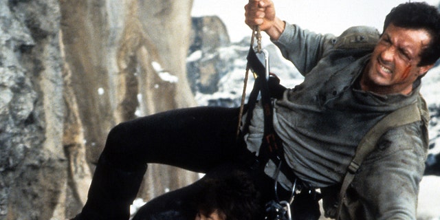 Sylvester Stallone rapelling down a cliff in "Cliffhanger"