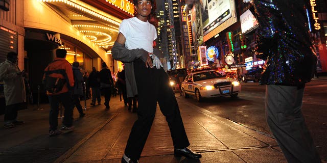 Two Michael Jackson impersonators on the street in at night