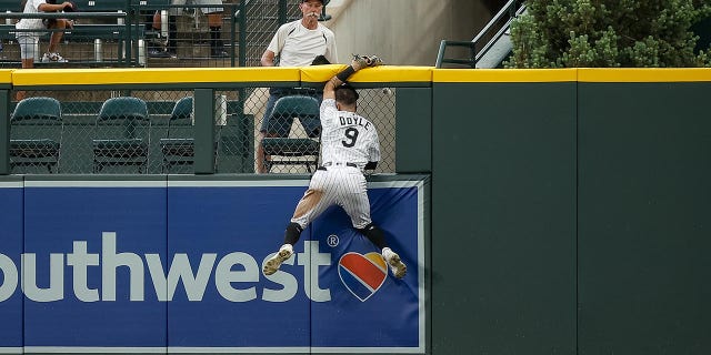 Brenton Doyle crashes into the center field wall