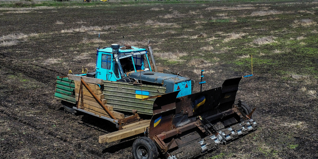 Ukraine tractor scans for Russian mines