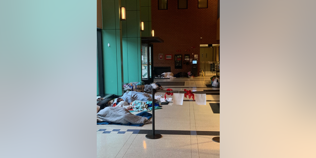 Migrants sleeping on police station floor