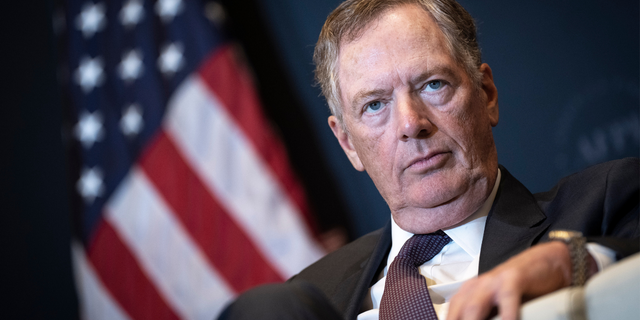 Robert Lighthizer with an American flag behind him