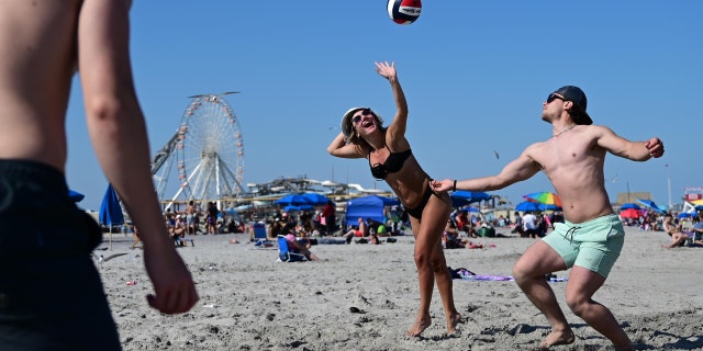 People play volleyball on the beach in Wildwood, New Jersey