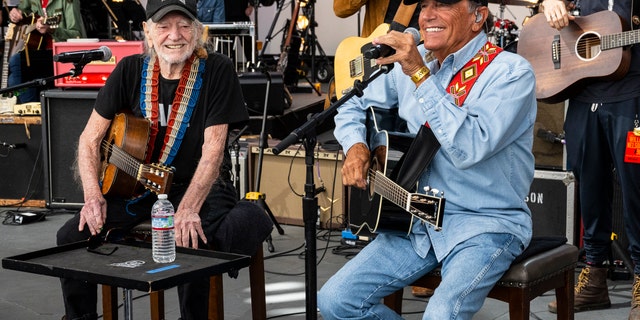 Willie Nelson performing with George Strait