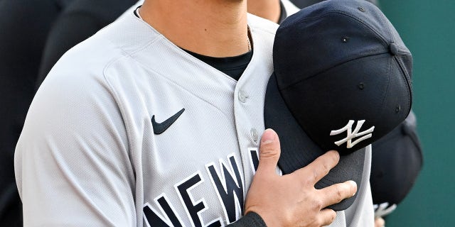 Anthony Volpe puts his hat on his chest