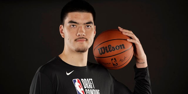 Zach Edey poses with basketball