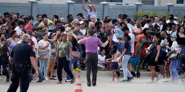 people gathering outside mall