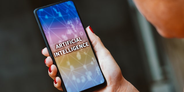 The words artificial intelligence on a phone screen