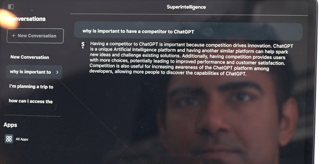 AI developer Arvin Bhangu's face reflects off of his iPad while he searches his app Superintelligence