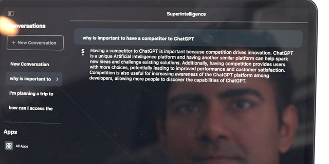 AI developer Arvin Bhangu's face reflects off of his iPad while he searches his app Superintelligence