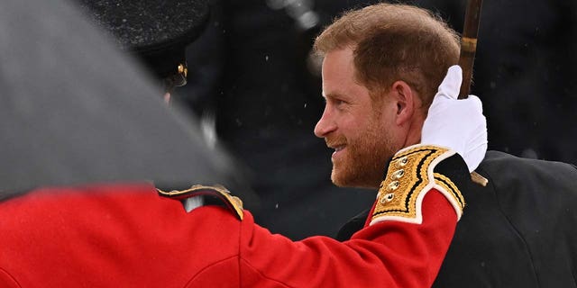 Prince Harry, Duke of Sussex, walks outside Westminster Abbey ahead of Britain's King Charles' coronation