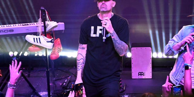 Brad Fischetti stands onstage during a concert.