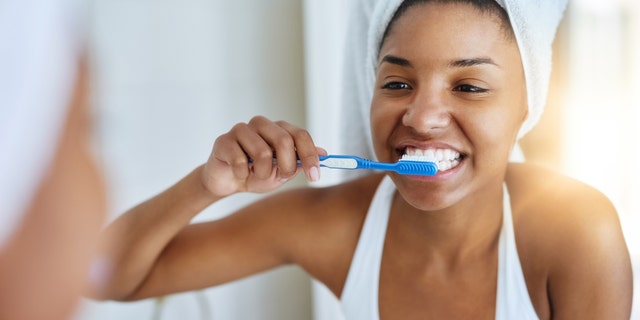 Woman brushing teeth