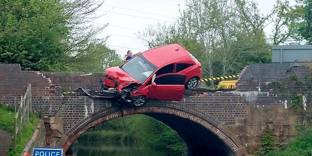 car dangles over bridge