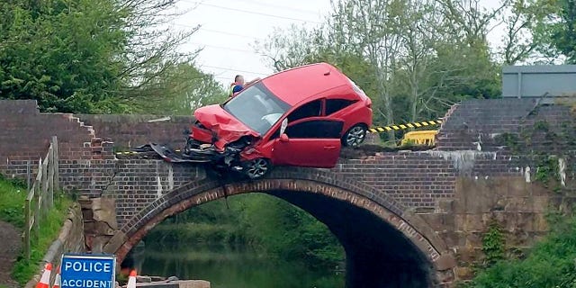 car dangles over bridge