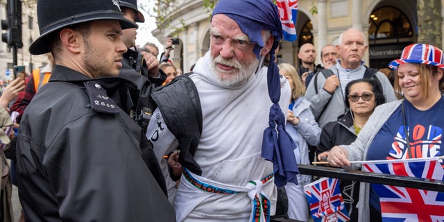 Police arresting man wearing a bandana