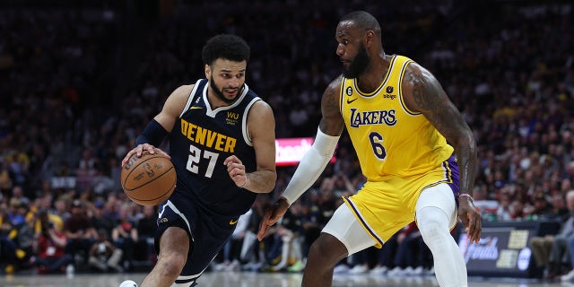 Jamal Murray #27 of the Denver Nuggets drives against LeBron James #6