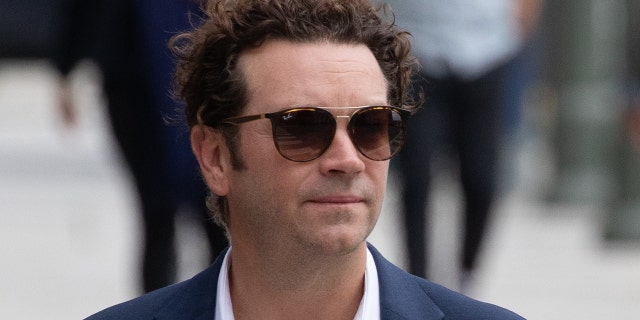 Danny Masterson wears a blue suit and sunglasses while arriving to court for rape trial in LA