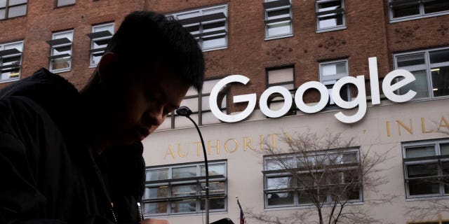 Man walking past Google
