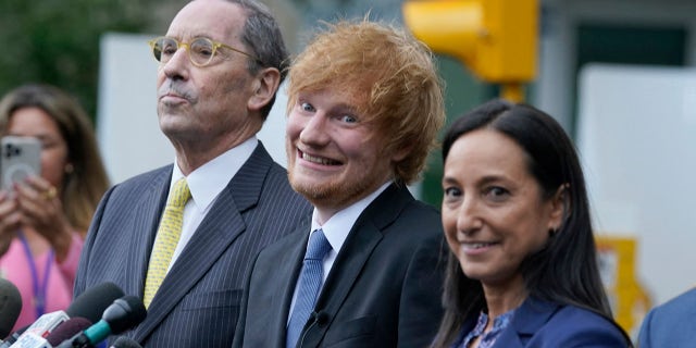 Ed Sheeran wears black suit with blue tie at Manhattan courthouse