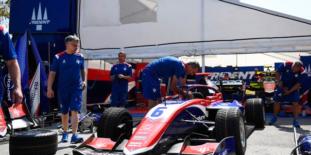 Team members working on car