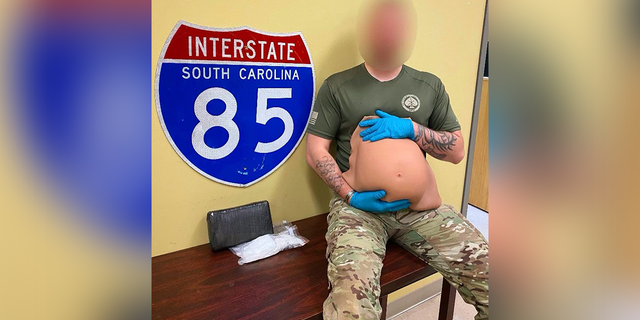 Deputy holds fake pregnancy belly