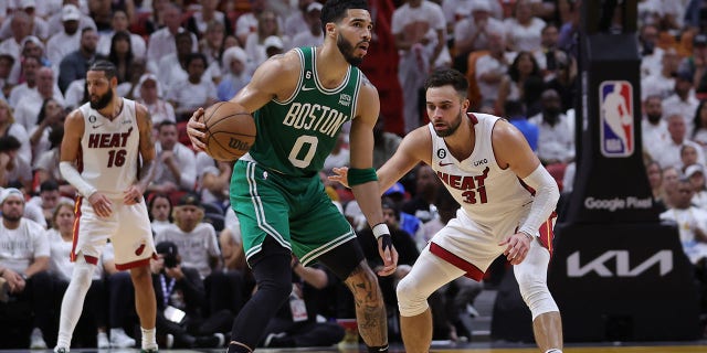 Max Strus escorts Celtics player Jayson Tatum