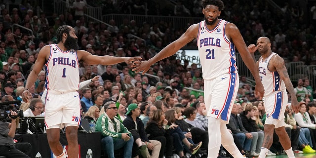 James Harden #1 of the Philadelphia 76ers high fives Joel Embiid #21