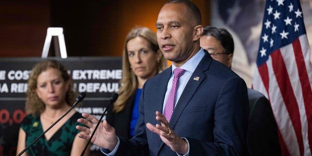 Minority leader in the US House of Representatives, Hakeem Jeffries, speaks from a podium alongside other members of the Democratic leadership in the House of Representatives