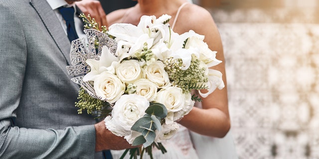 bride and groom together with flowers