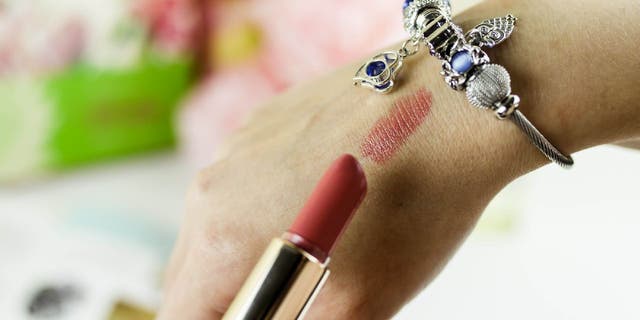 Lipstick swatch on hand.