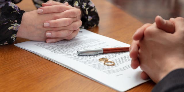 Divorce lawyer goes over paperwork with woman