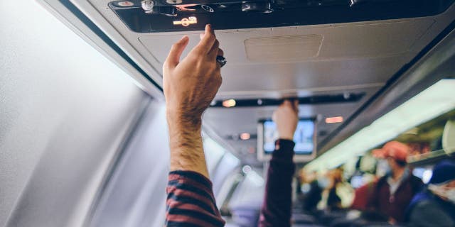 People adjust their airplane air conditioner settings.